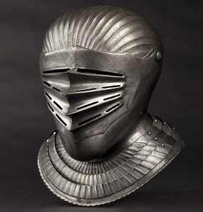 South German Maximilian style close helmet for a fluted suit of armour 1530. Hammer Price: 30,000 Euros.