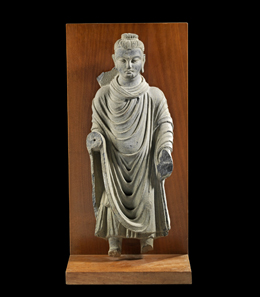 Lot 655: Buddha, Gandhara, ca. 2nd cent, AD. H 51cm, W 19.5 cm, D 9.5 cm. Green grey slate. From the Prof. Dr. Günther Marschall Collection, Hamburg. Acquired 1967-1975. Nimbus, forearms, feet and small parts of coat hem broken. Estimate: 6,000,- euros. Hammer price: 14,000,- euros.
