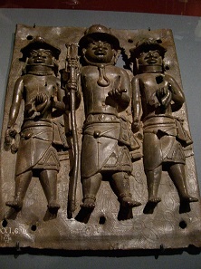 Benin Bronze: the King’s local slave agents, holding European manillas in their hands. Photo: UK.