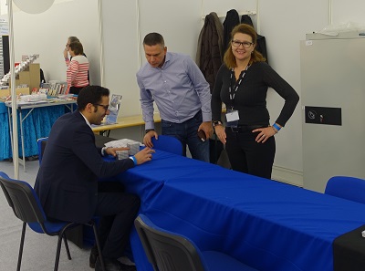 They can still laugh: The NGC-Team before the storm of people who want to collect their coins, graded in Munich.