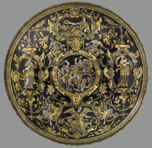 The Ghisi Shield. Hammered iron, silver-plated and damascened with gold. About 1600. This shield is a display piece. Figures on the border symbolise Glory, Prudence, Fame and Strength. The Waddesdon Bequest. © The Trustees of the British Museum.