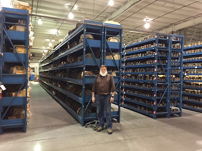 Rob Vugteveen in front of the shelves of dies and galvanos at NWTM, Dayton, Nevada.