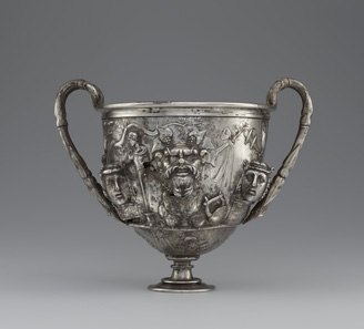 Cup with Masks. Roman, 1-100 CE. Inscription: MERCVRIO AVGVSTO Q DOMITIVS TVTVS EX VOTO (To Augustan Mercury, Quintus Domitius Tutus in fulfillment of a vow). Find-spot: Berthouville, France. Silver. H. 15.8 cm; W. 19 cm; Diam. 13.3 cm. Bibliothèque nationale de France, Paris: inv. 56.9. Photo: Tahnee Cracchiola © Getty-BnF.