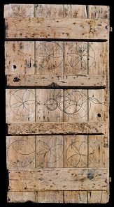 Oak calf-shed door marked with magical symbols to protect livestock. From Laxfield, Suffolk, 19th century. 183 x 94 cm. Private collection.