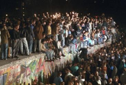 A photo of people who climbed the Berlin Wall on November 9, 1989.