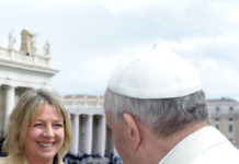 Taya Pobjoy presents coin to Pope Francis